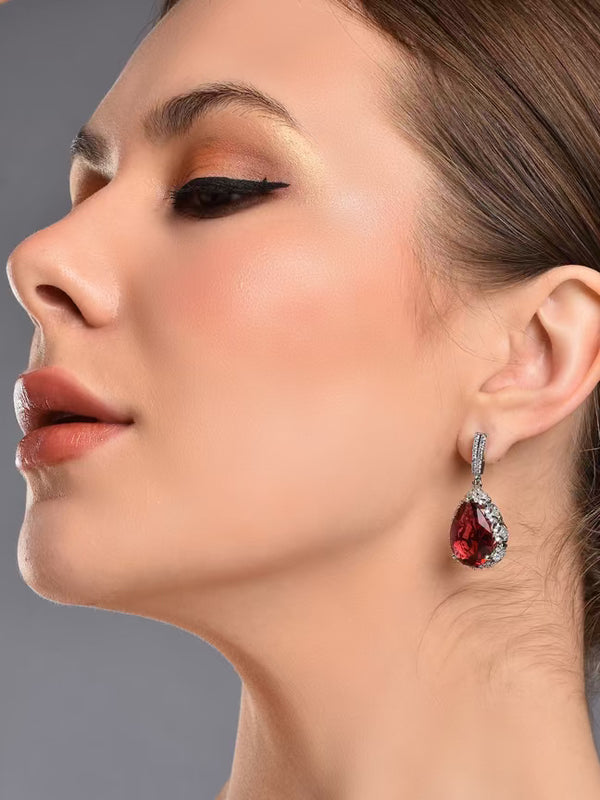 Ruby red teardrop earrings from The Diwali Drop, worn by a model